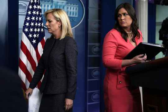 WASHINGTON, DC - JUNE 18:  U.S. Secretary of Homeland Security Kirstjen Nielsen (L) leaves after she briefed members of the press as White House Press Secretary Sarah Sanders (R) looks on during a White House daily news briefing at the James Brady Press Briefing Room of the White House June 18, 2018 in Washington, DC. Nielsen joined White House Press Secretary Sarah Sanders at the daily news briefing to answer questions from members of the White House Press Corps.   (Photo by Alex Wong/Getty Images)