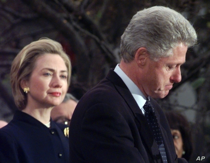 FILE - Then first lady Hillary Clinton watches her husband, President Bill Clinton, pause as he thanks those Democratic members of the House of Representatives who voted against his impeachment, Dec. 19, 1998. Clinton was impeached by the House but l... FILE - Then first lady Hillary Clinton watches her husband, President Bill Clinton, pause as he thanks those Democratic members of the House of Representatives who voted against his impeachment, Dec. 19, 1998. Clinton was impeached by the House but l...